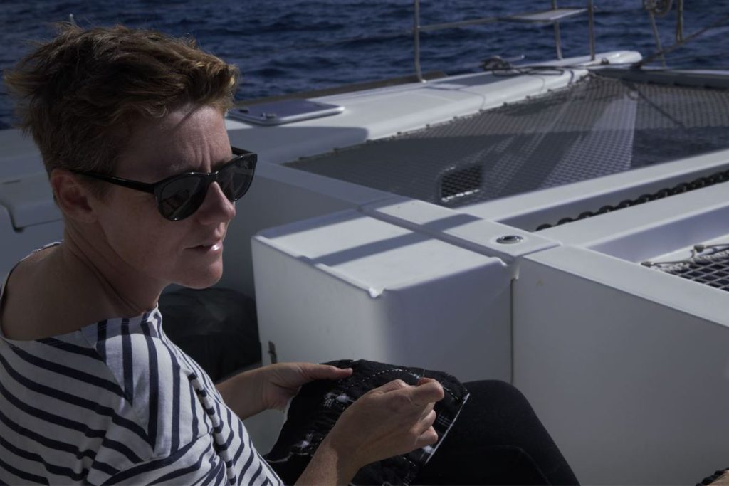 Elli Beaven stitching on her 44ft long catamaran