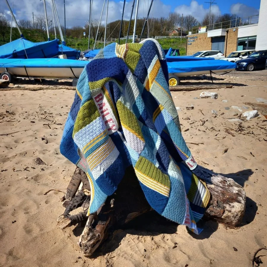 amazing Knitted blanket designed and created by graduate Lynn Hall, displayed on the beach