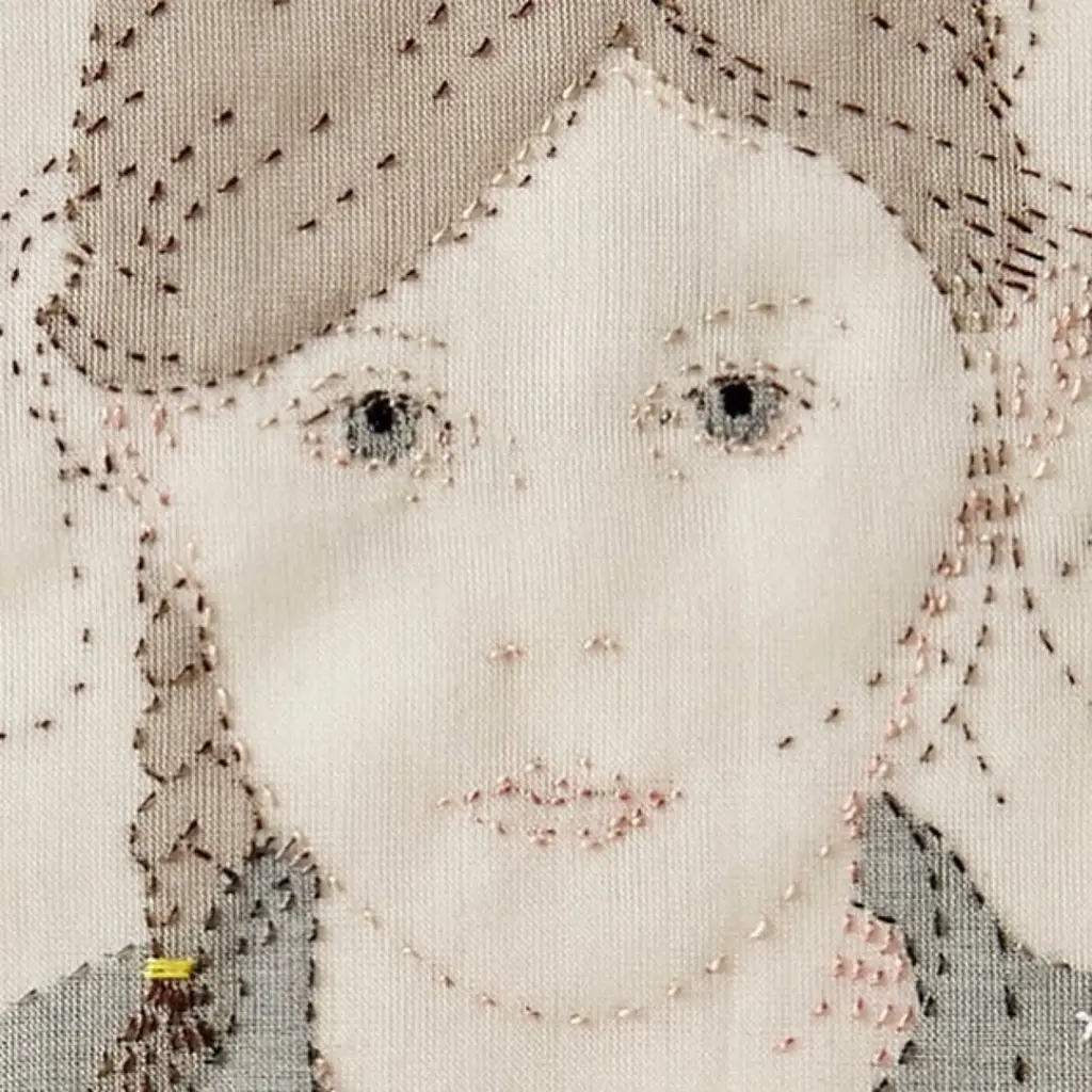 Up close detail of hand stitched portrait